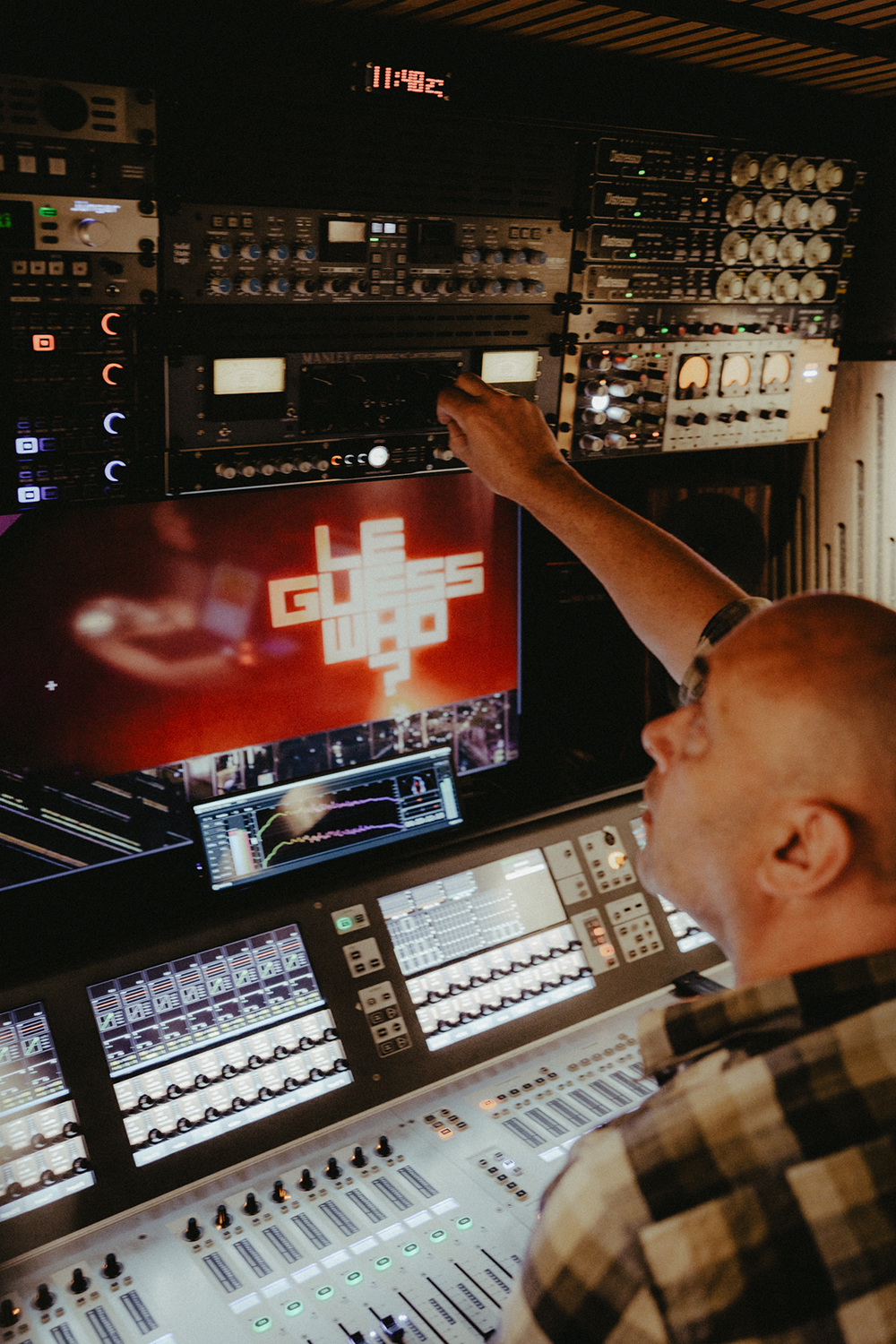 A photo of Marc Broer in his recording van. You can see all kinds of different sound panels and the Le Guess Who? logo on a screen.